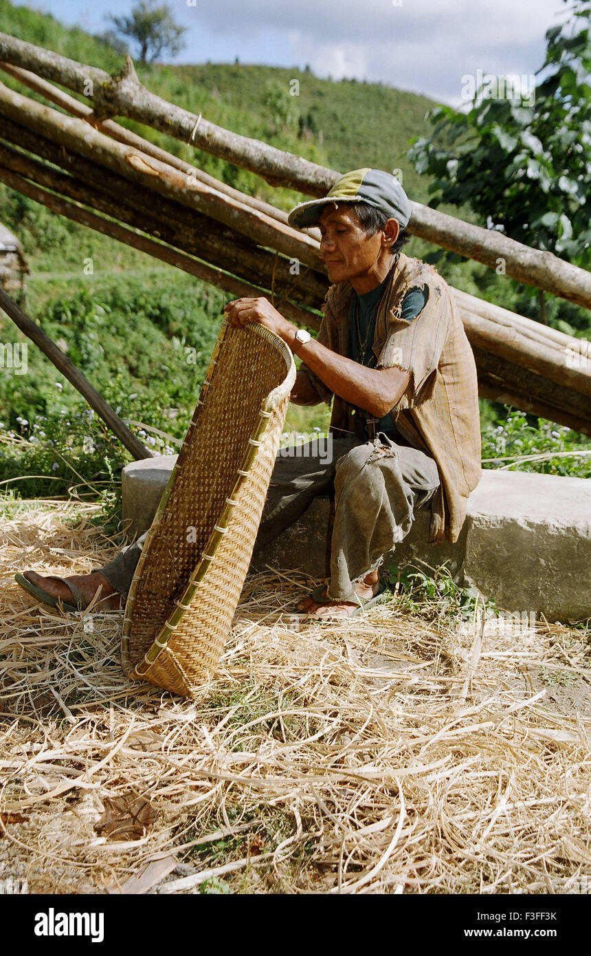 Rural man making winnowing basket ; Himachal Pradesh ; India ; Asia