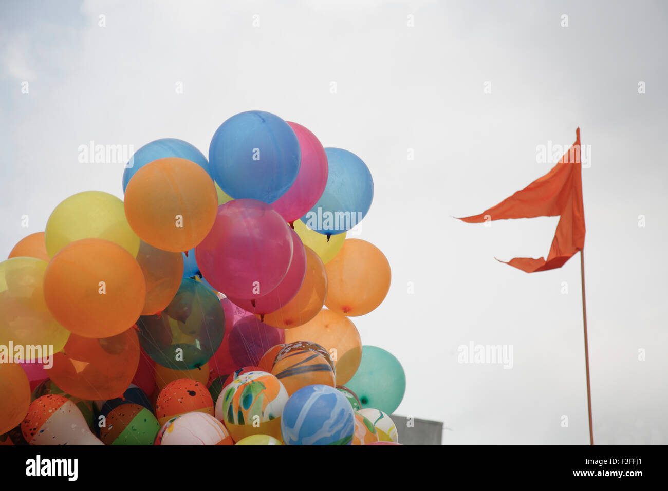 Colorful Balloons filled with gas lighter than the air ; saffron color