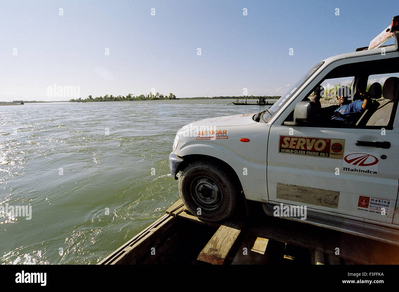 Car crossing river on boat ; India ; Asia ; Asian ; Indian Stock Photo
