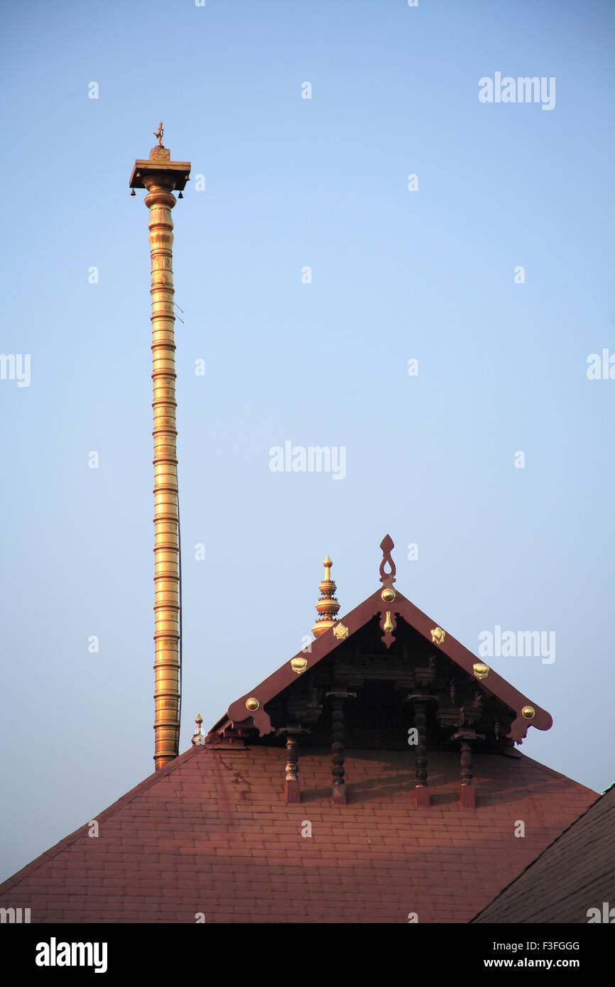 Dhwajasthambam or flag staff encased in plated gold at height of 600 feet and roof of Guruvayur temple Thrissur Kerala Stock Photo