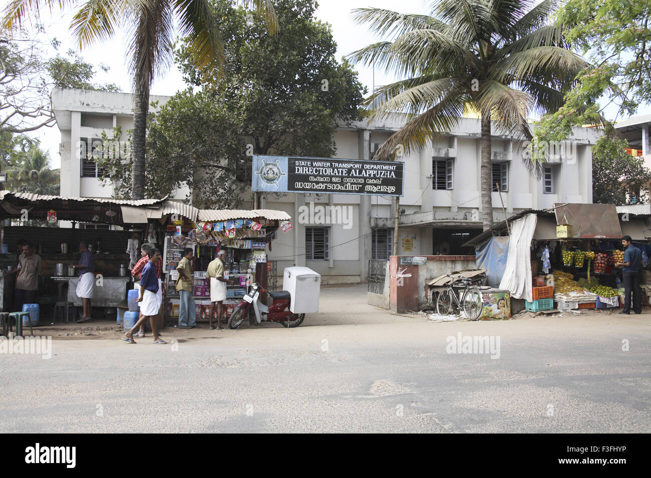 Small shops on road and building of State Water Transport Department ; directorate ; Alappuzha Alleppey ; Kerala Stock Photo