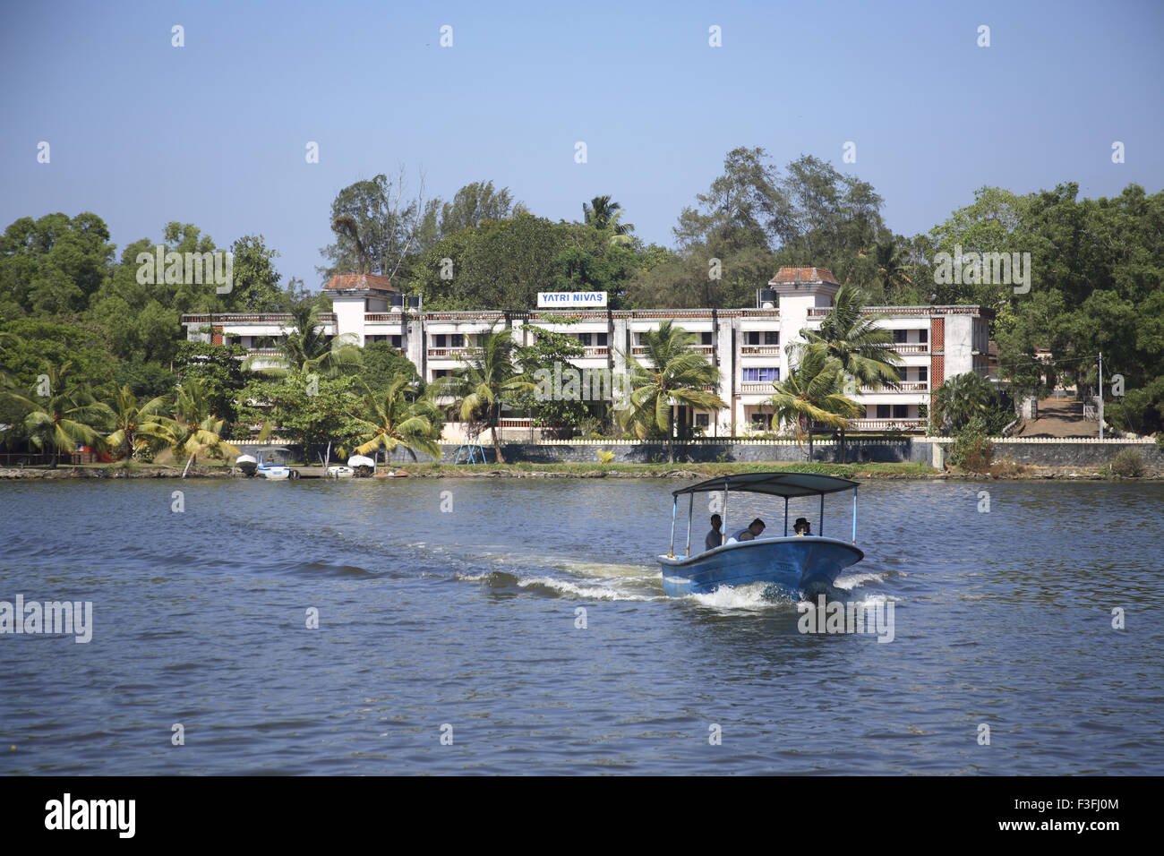 Tourism accommodation Yatri Niwas in front of Ashatmudi lake ; Kollam ; Kerala ; India Stock Photo