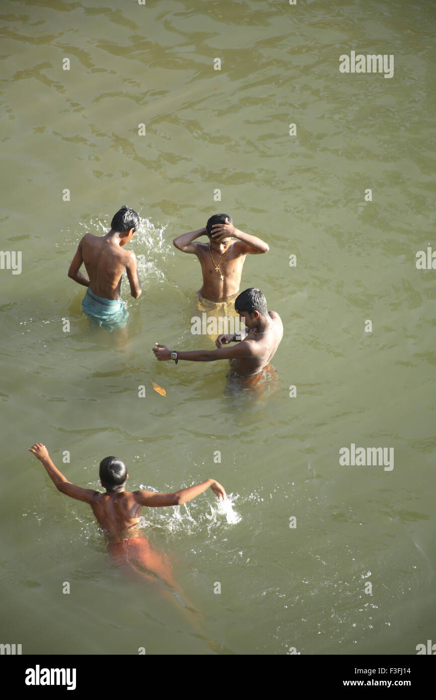 Boys bathing and swimming in backwaters ; Kerala ; India Stock Photo
