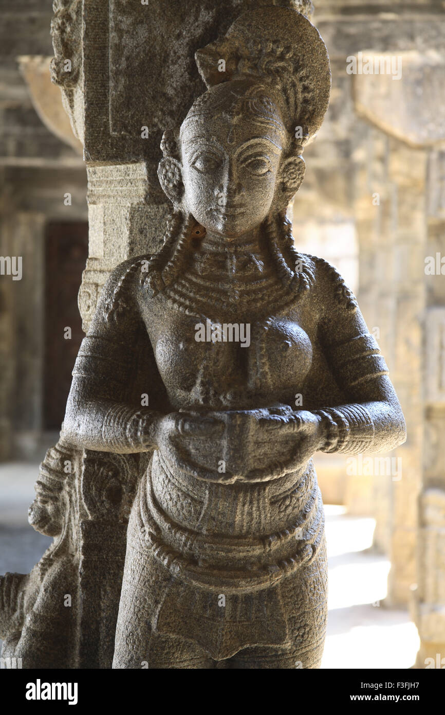 Carved figurines carrying lamps ; Carving pillars ar Nataksala solid granite pillars Padmanabhapuram Wood Pale ; Tamil Nadu Stock Photo