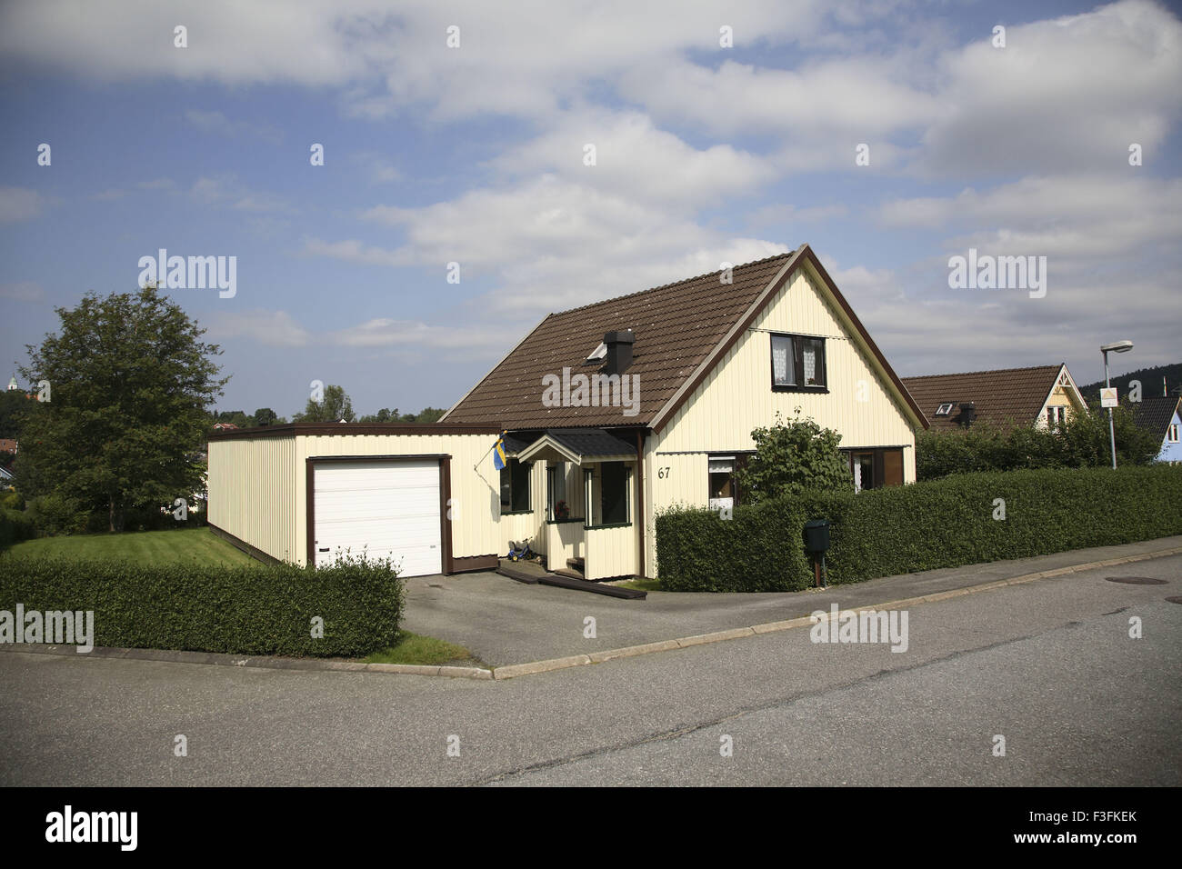 House or Villa with green fence of bushes compound and garage ; Skepplanda ; Sweden Property release No.703 L Stock Photo