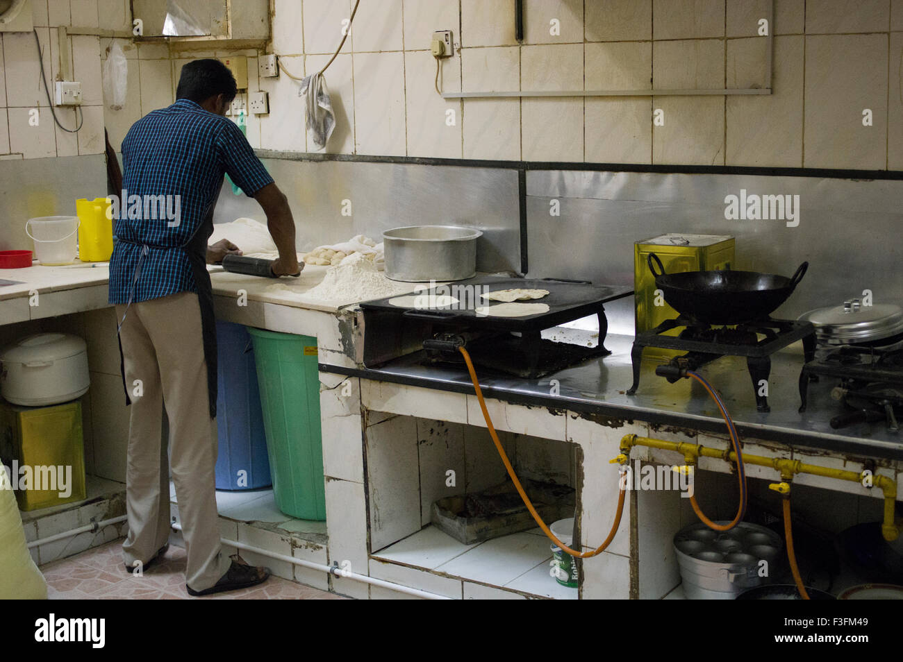 A chef cooking chapatis in a small restaurant in Muscat in the
