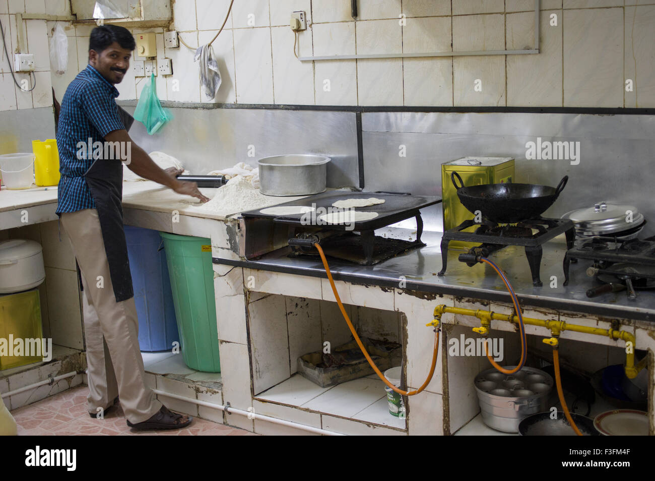 A chef cooking chapatis in a small restaurant in Muscat in the