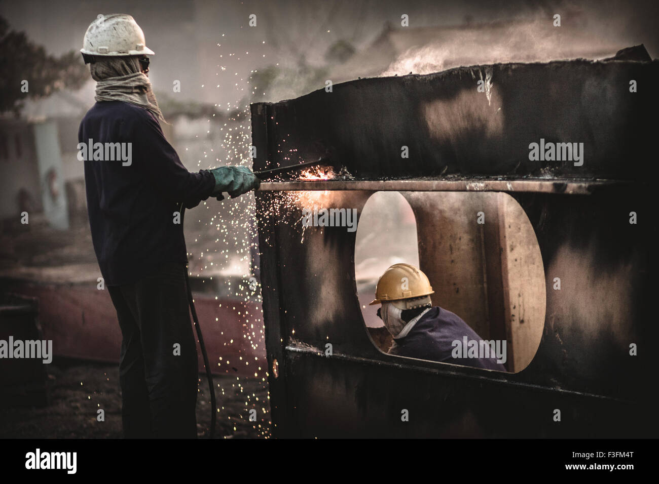 Shipbreaking Yards of Alang. workers Stock Photo