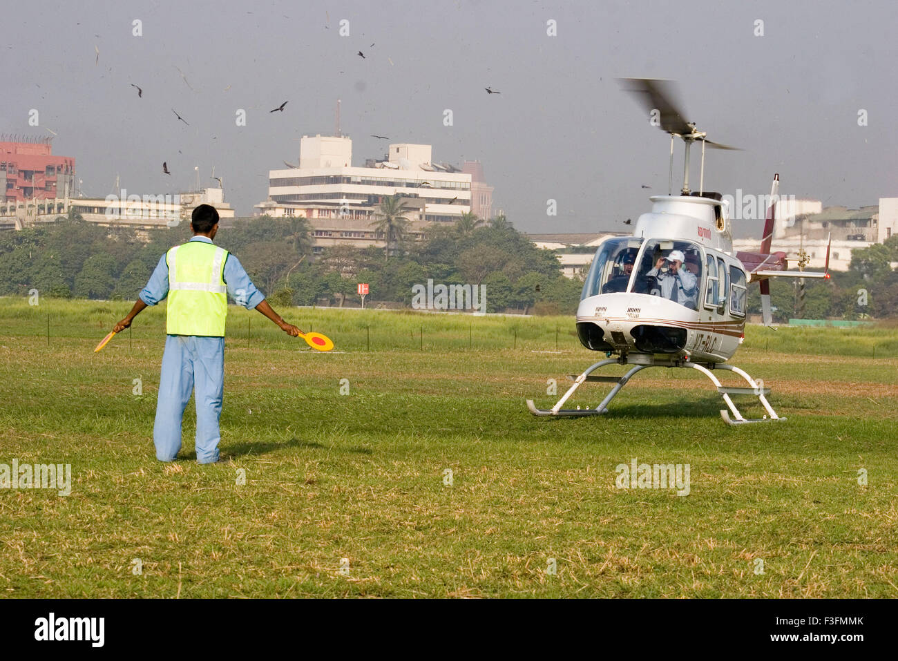Air transport ; man giving direction for landing Helicopter Stock Photo