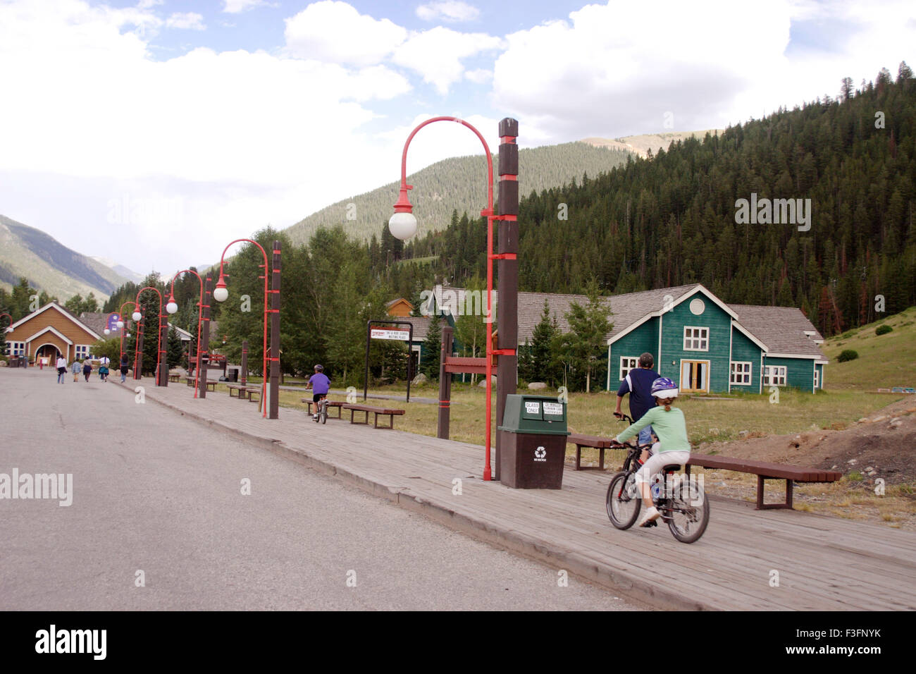 Boy and girl cycling on side of road at Silver stone ; Colorado ; U.S.A. United States of America Stock Photo