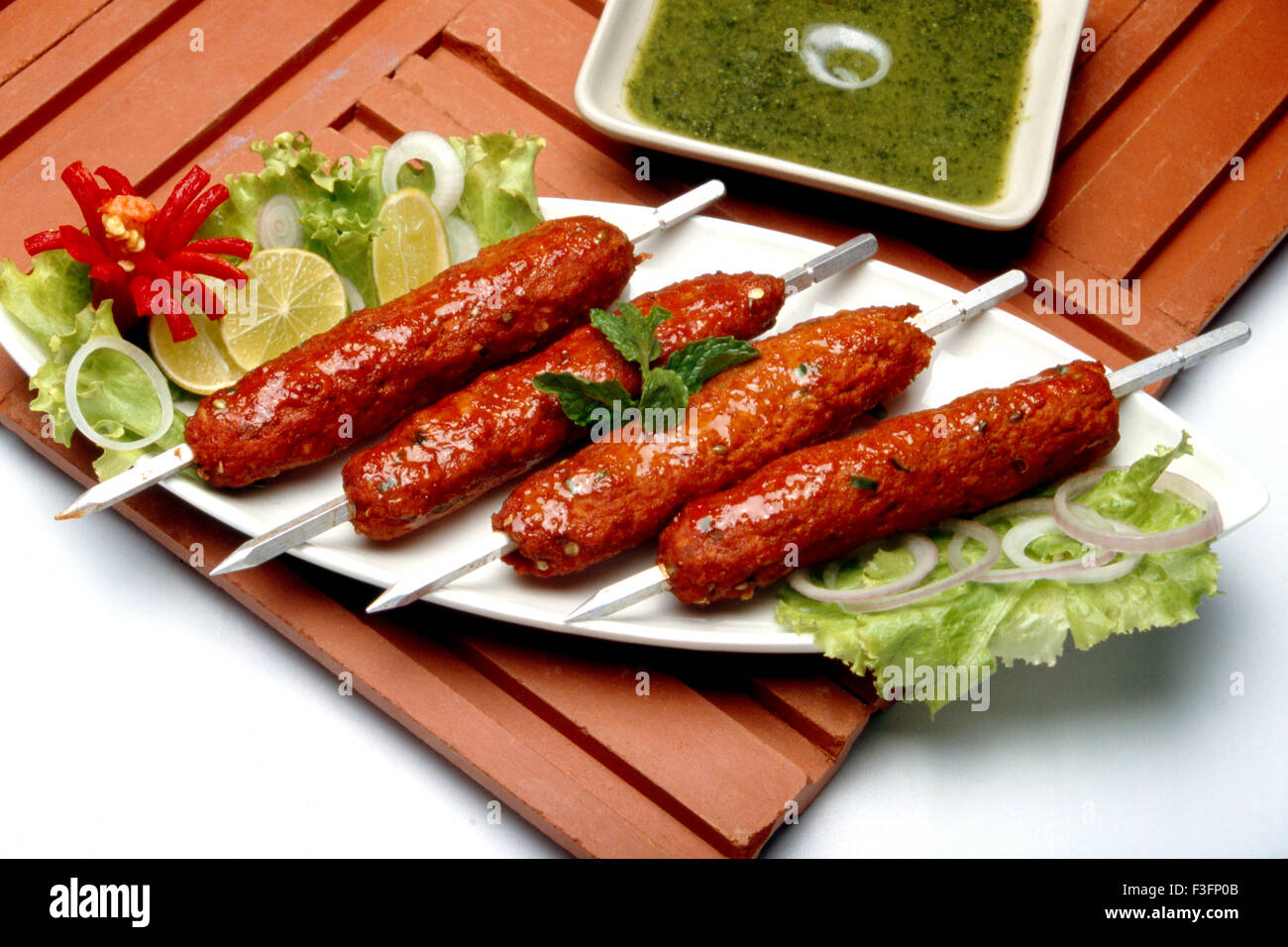Non vegetarian dish ; Seek Kebab with stick served in dish Stock Photo