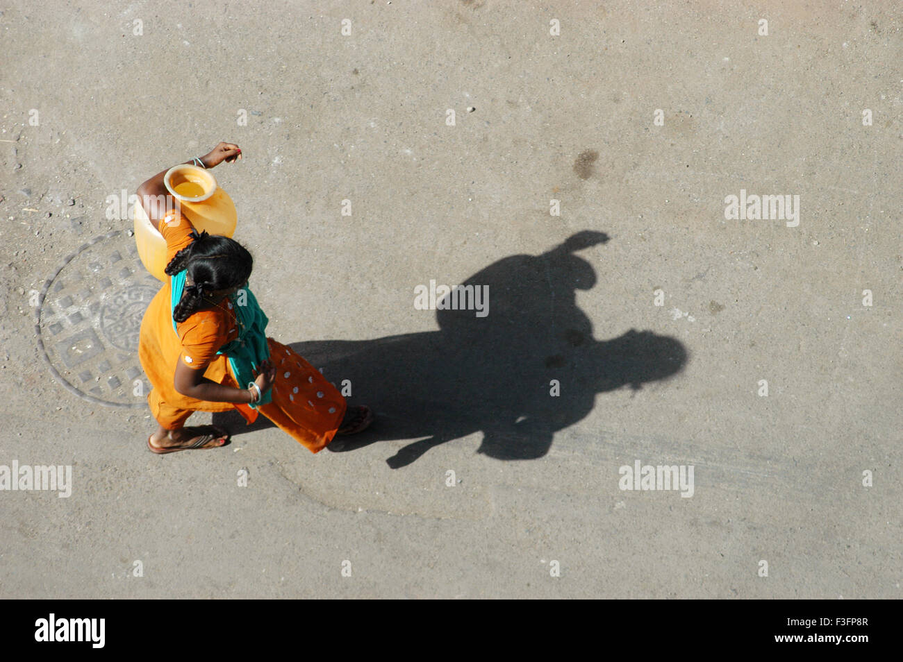 Slum dweller carries plastic container in hand ; Bombay Mumbai ; Maharashtra ; India Stock Photo