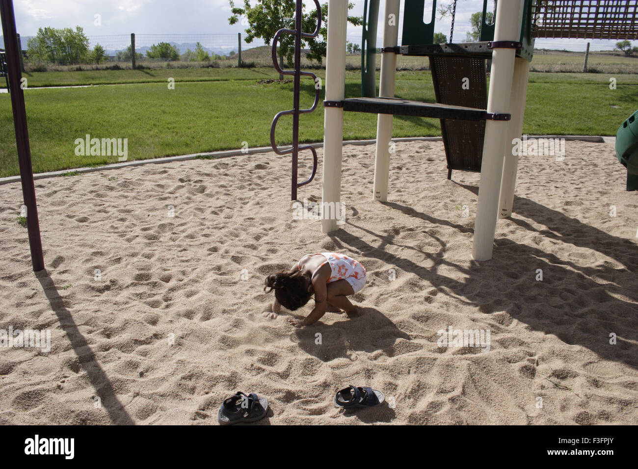 Tree years old child playing in sand in park MR#0543 Stock Photo