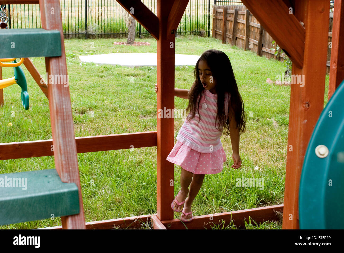 Four years old girl playing on play ground Stock Photo