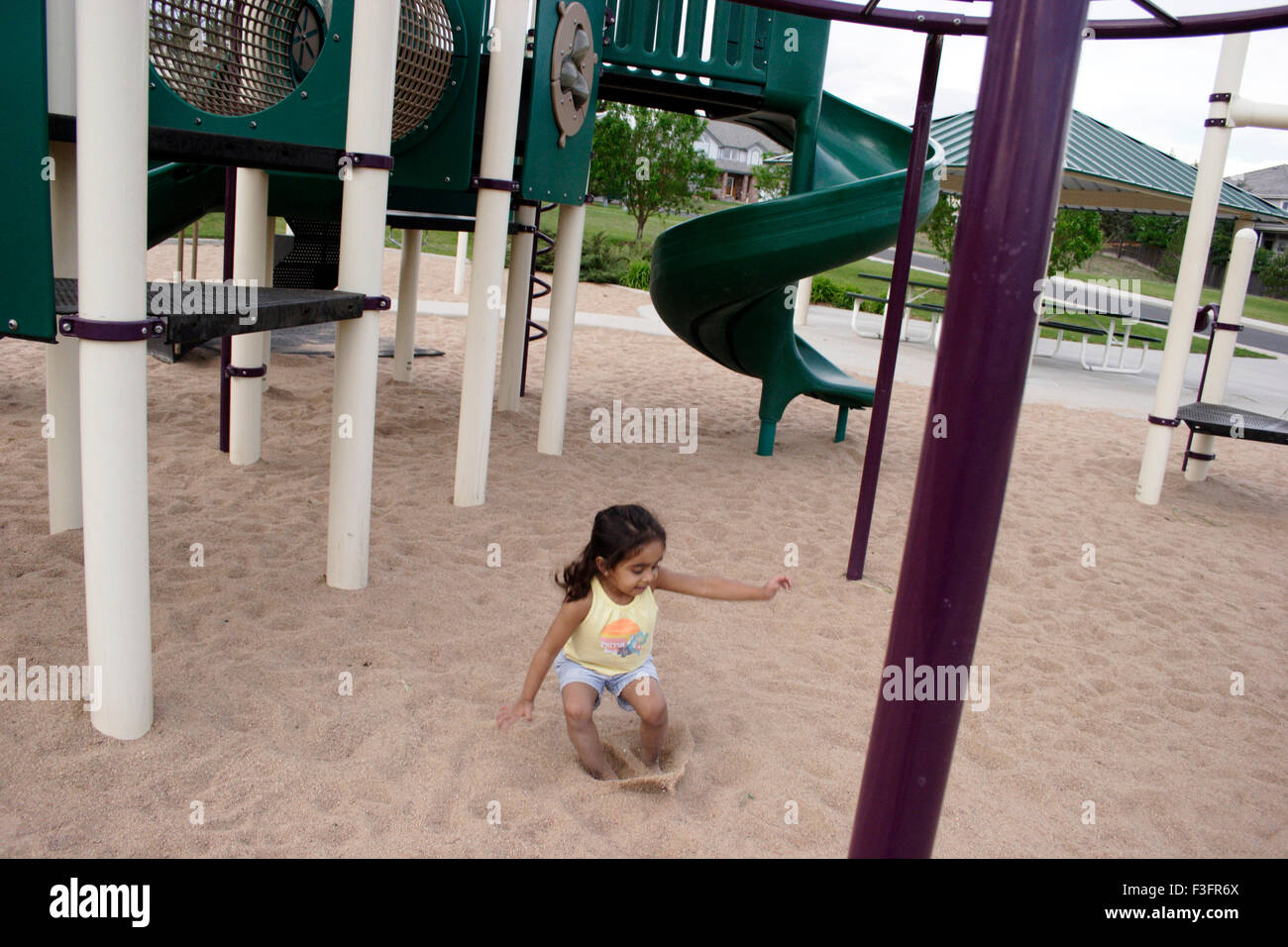 Three years old girl playing in sand Stock Photo