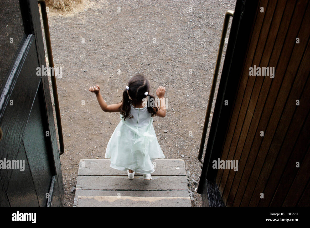 Three years old girl getting down from compartment MR#0543 Stock Photo