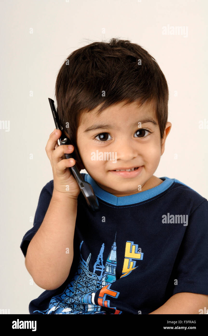 Boy listening on cell phone ; MR Stock Photo Alamy