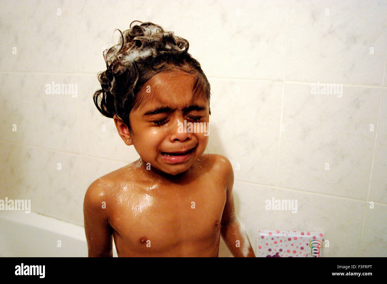 Girl started crying at the time of bathing Stock Photo Alamy