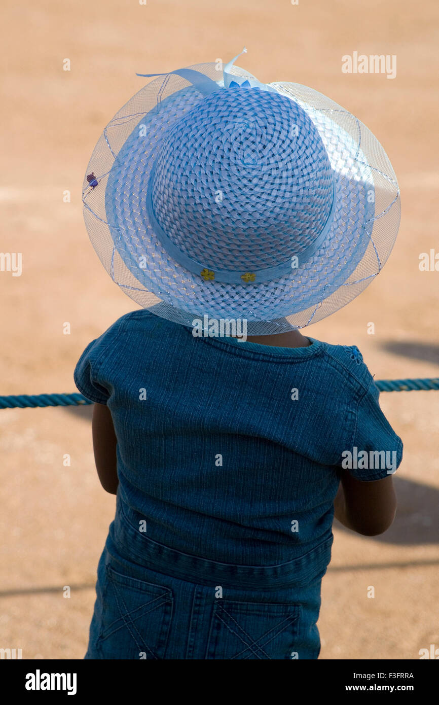Little girl with blue hat let no boundaries ; India Stock Photo