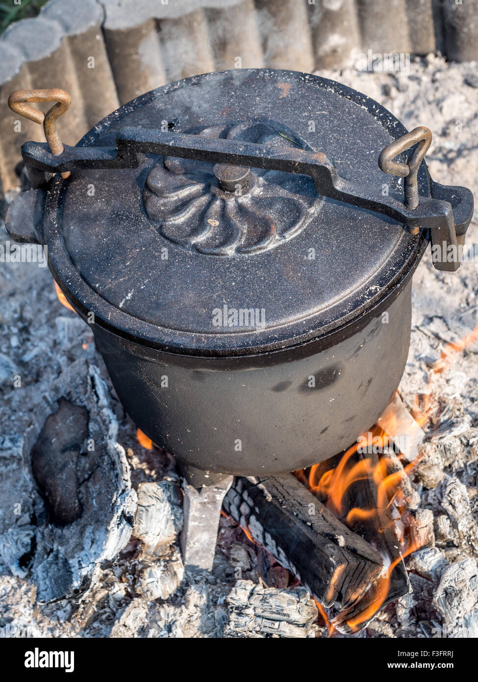 Black castiron kettle with fare placed on fire Stock Photo Alamy