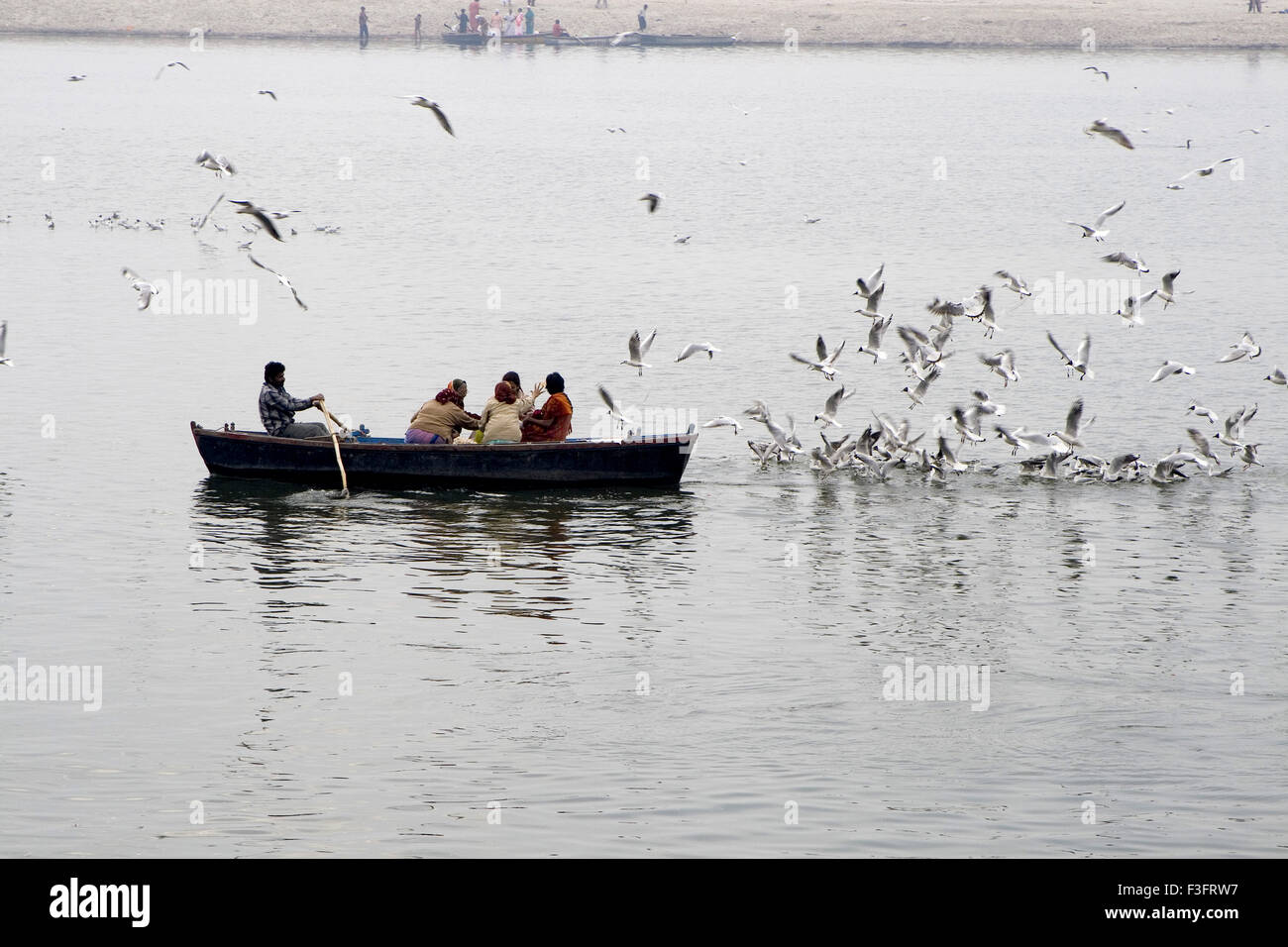 Tourists in boat on Ganga river in Varanasi ; Uttar Pradesh ; India Stock Photo