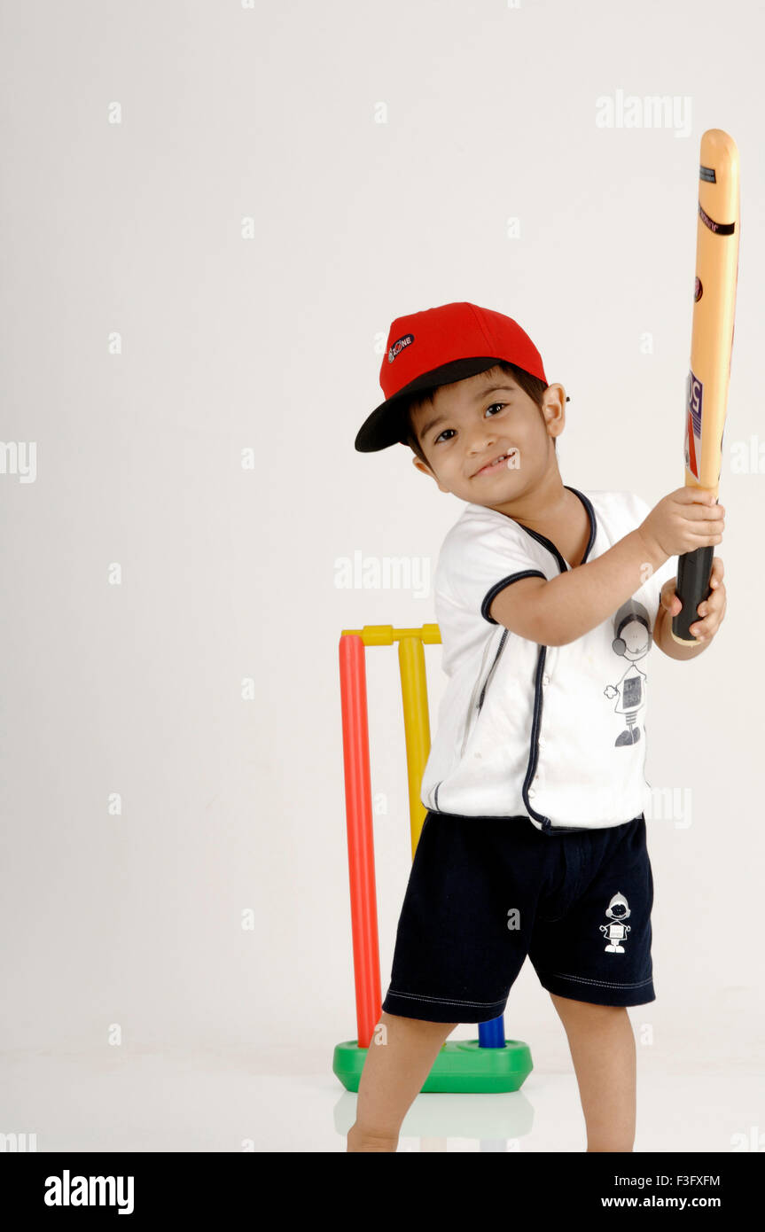 Indian Boy swinging bat in the Air Superhit playing cricket ; MR Stock Photo