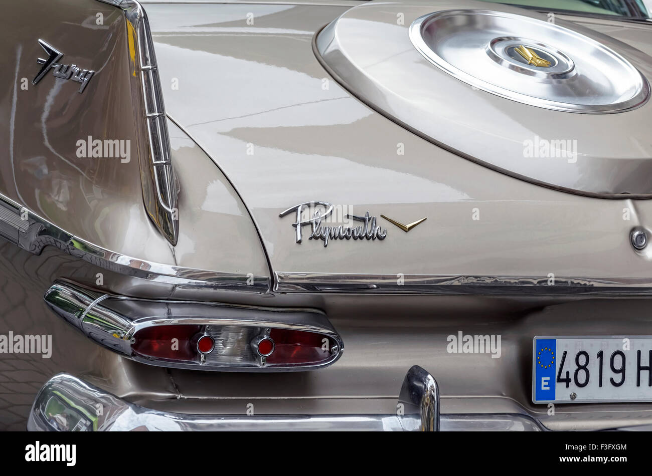 Meeting of classic american cars. Partial rear view of champagne color car, Plymouth Fury of 1959. Stock Photo