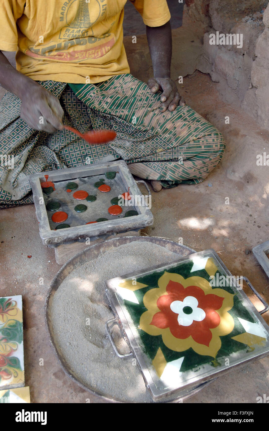 Man making Athangudi tiles which are not ceramic quite heavy and costly