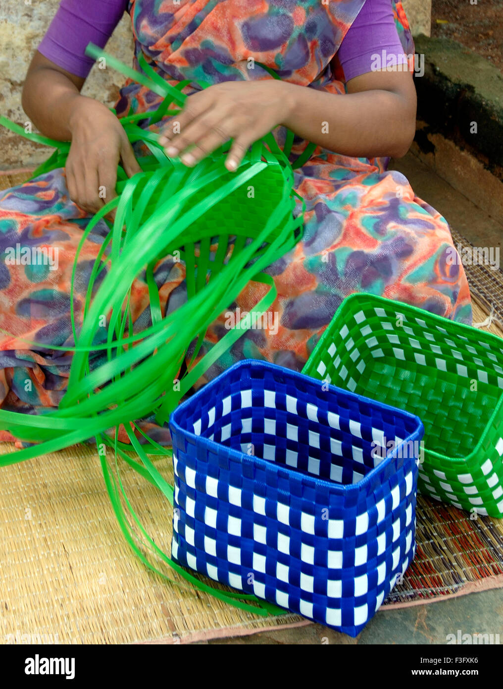 Cottage industry; woman weaving plastic strips baskets ; Tamil Nadu