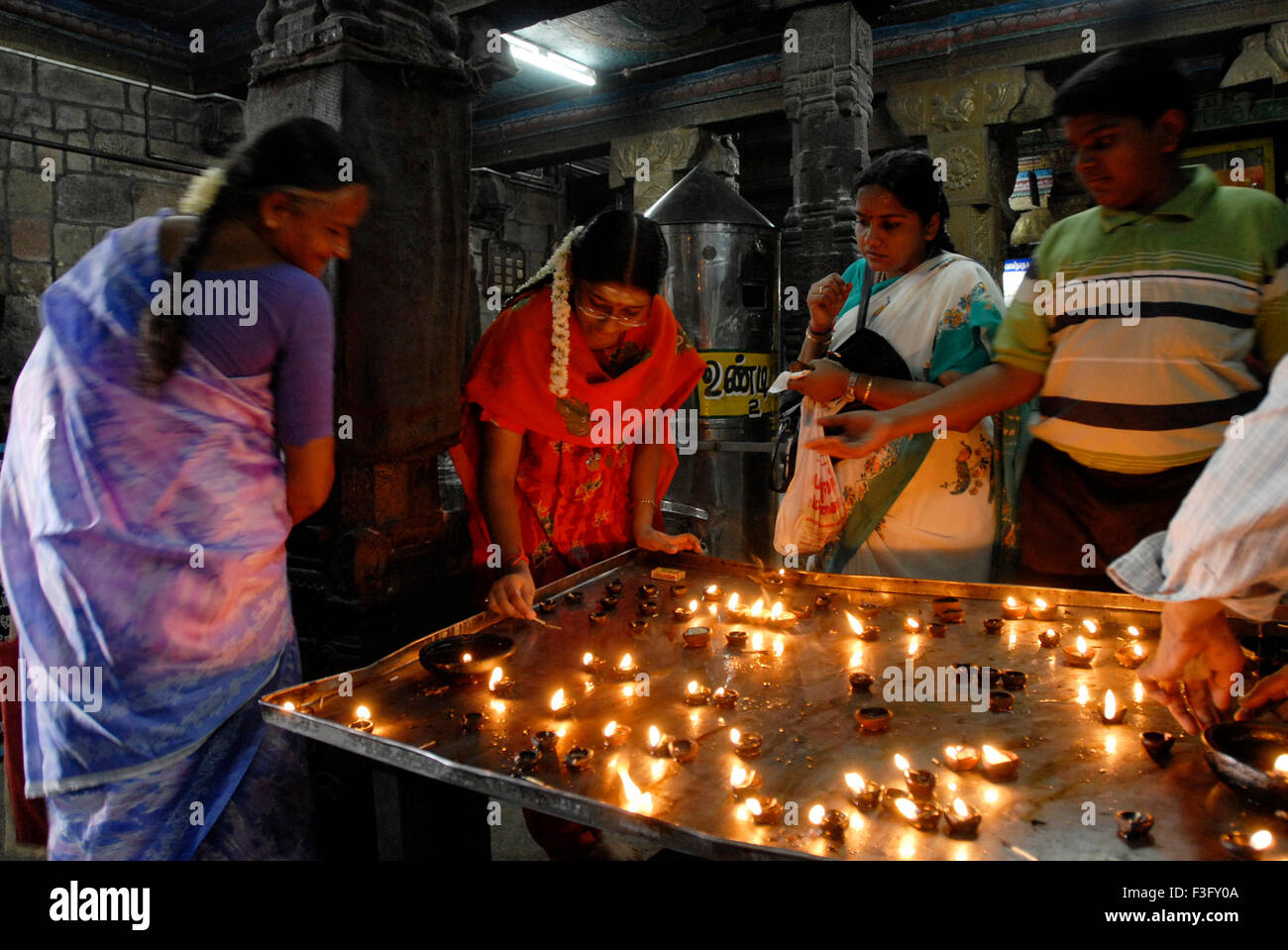 Lighting oil lamp in Swaminatha Swami temple ; Swamimalai ; Tamil Nadu