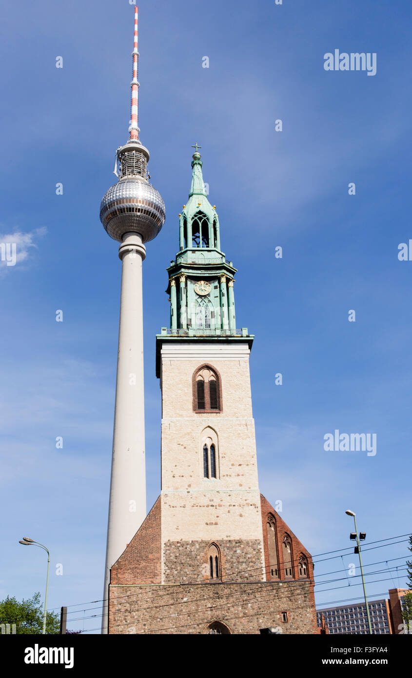 Berlin Fernsehturm TV Tower next to St Mary's Church, Berlin Stock Photo