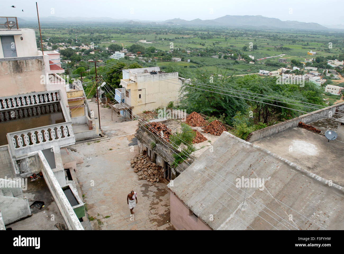 Road behind temple with small houses ; Tirutani ; Tamil Nadu ; India Stock Photo