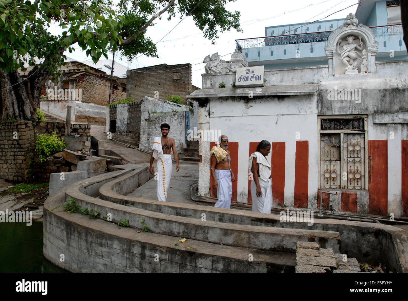 Road behind temple with small houses ; Tirutani ; Tamil Nadu ; India Stock Photo