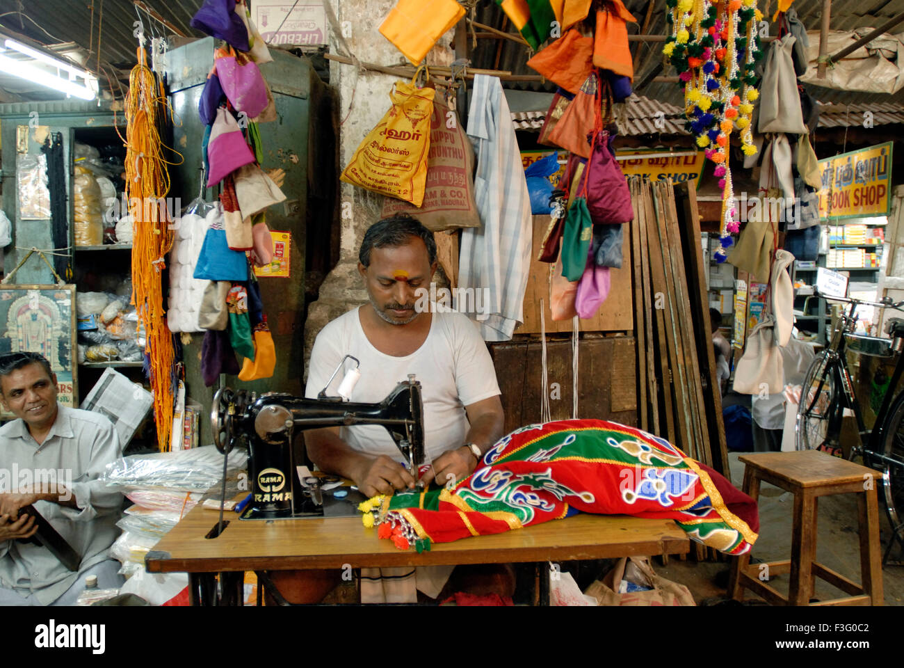 Tailoring shops at Pudumandapa the 328 feet (30m) long hall built by Tirumalai Nayaka in 1635 ; Madurai ; Tamil Nadu ; India Stock Photo