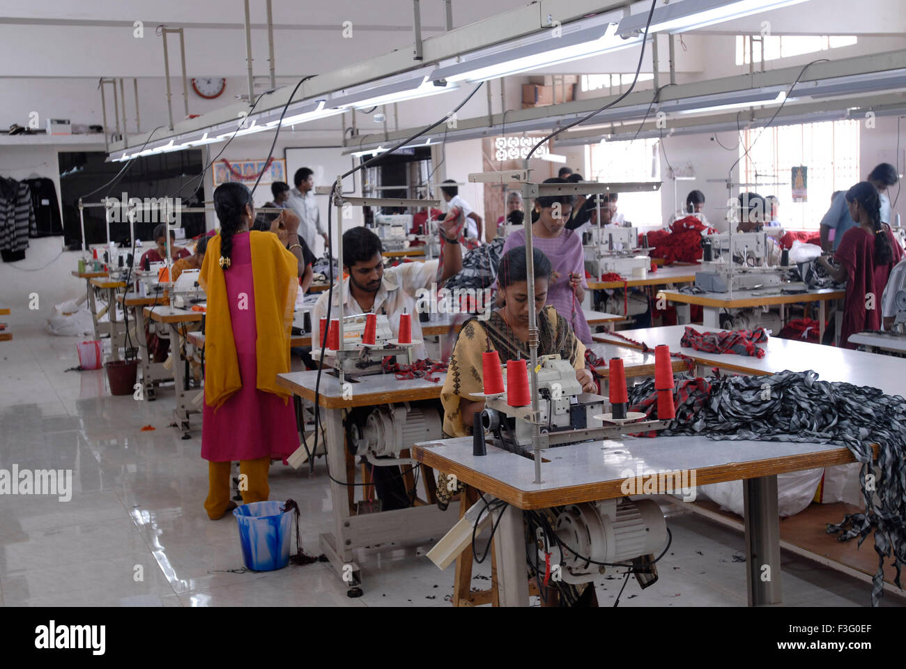 Stitching on sewing machines in garment factory , Tirupur , Tamil Nadu