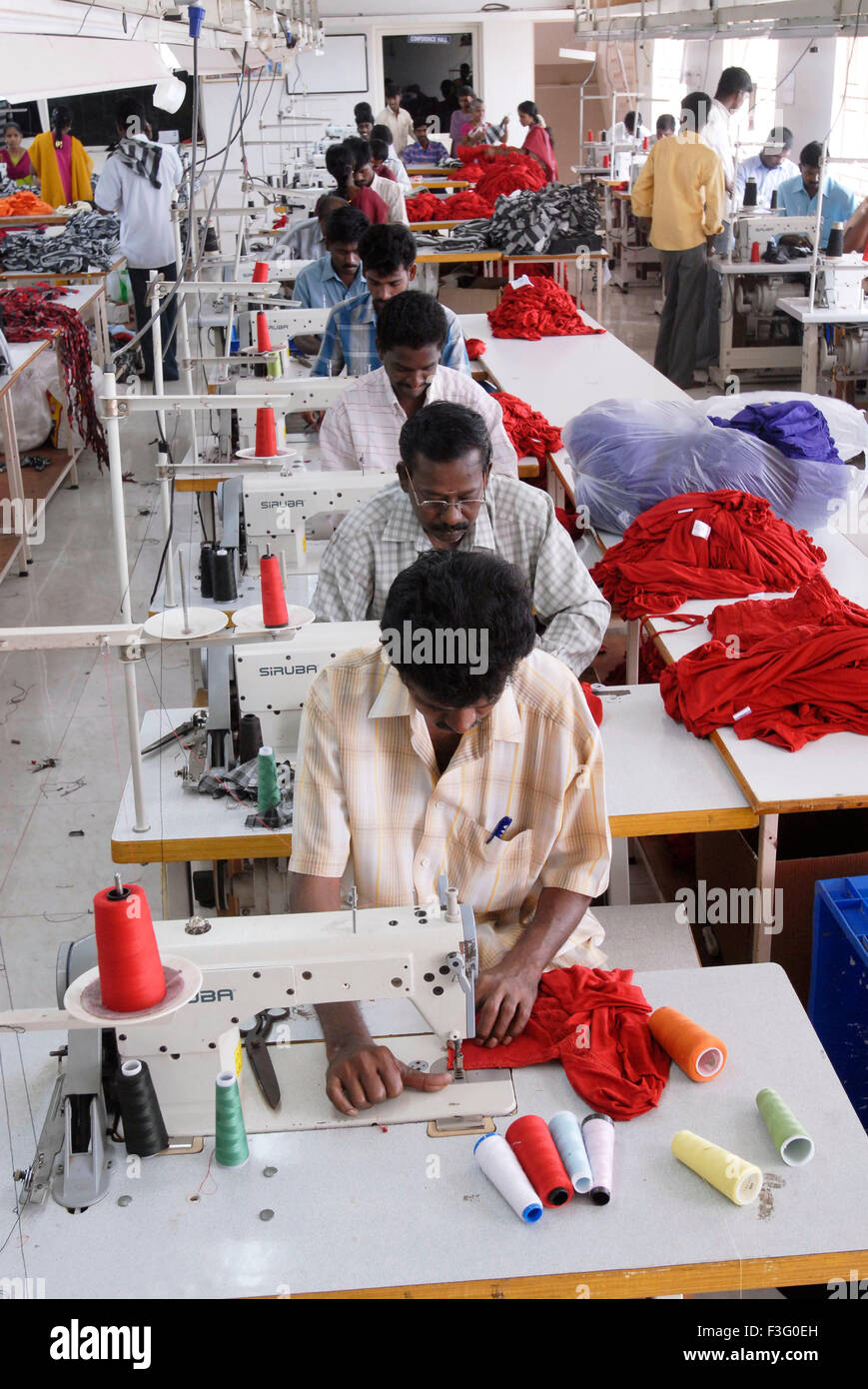 Stitching in a garment industry ; Tirupur ; Tamil Nadu ; India Stock Photo