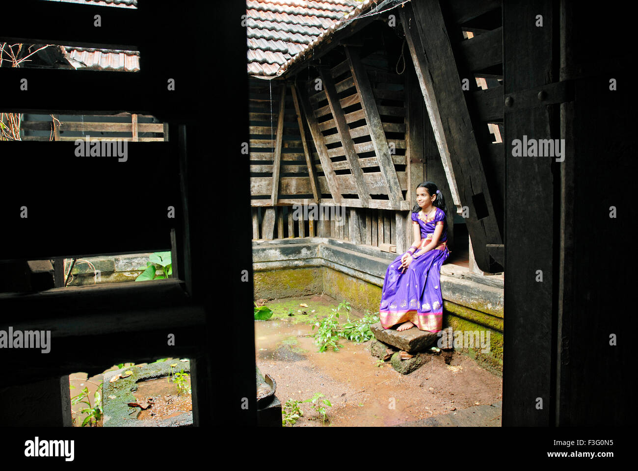 Namboothiri girl sitting in 175 years old Perumangatu Mana in Panjal ; Kerala ; India Stock Photo