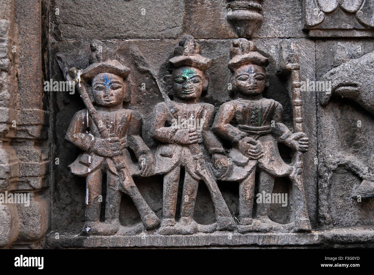 Soldiers carved in stone on the entrance ; Trishundi Ganesh Mandir (1753) ; Pune ; Maharashtra ; India Stock Photo