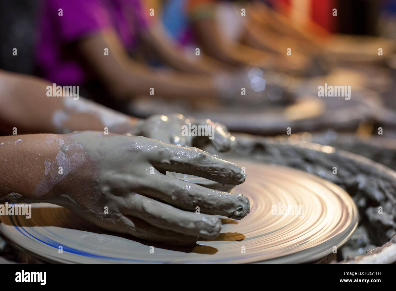 Children learning to work with potter's wheel Stock Photo Alamy