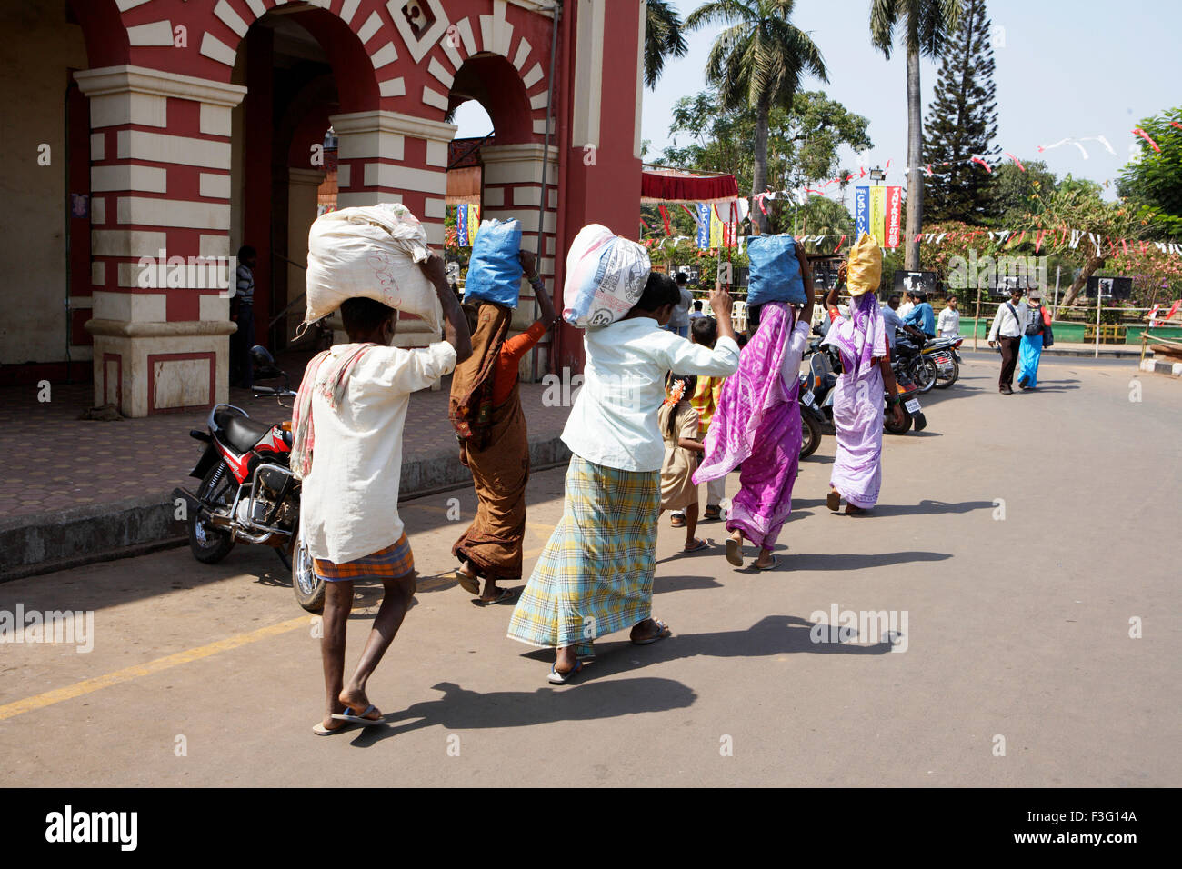 Villagers carrying bags on head ; Margaon ; Goa ; India Stock Photo