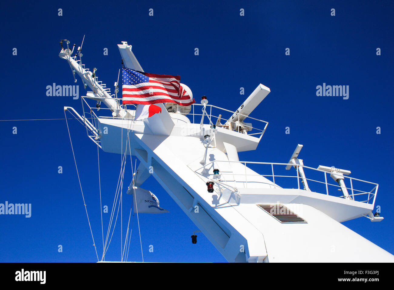 U.S.A. flag over cruise ship telecommunication systems ; New Orleans ; Louisiana ; U.S.A. United States of America Stock Photo