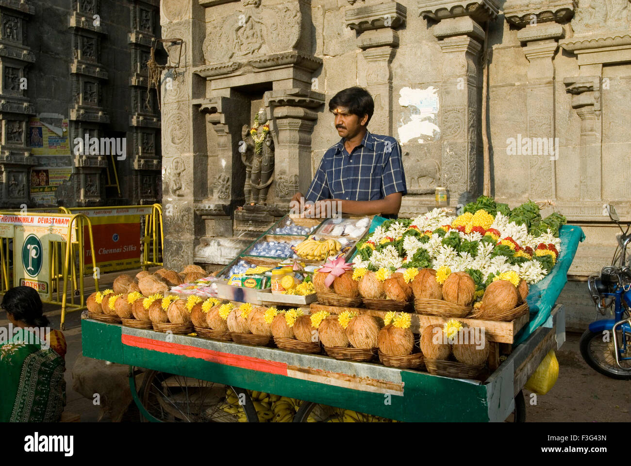 Man selling Pooja integrants on stall ; Thiruvannamalai temple ; Tamil Nadu ; India Stock Photo