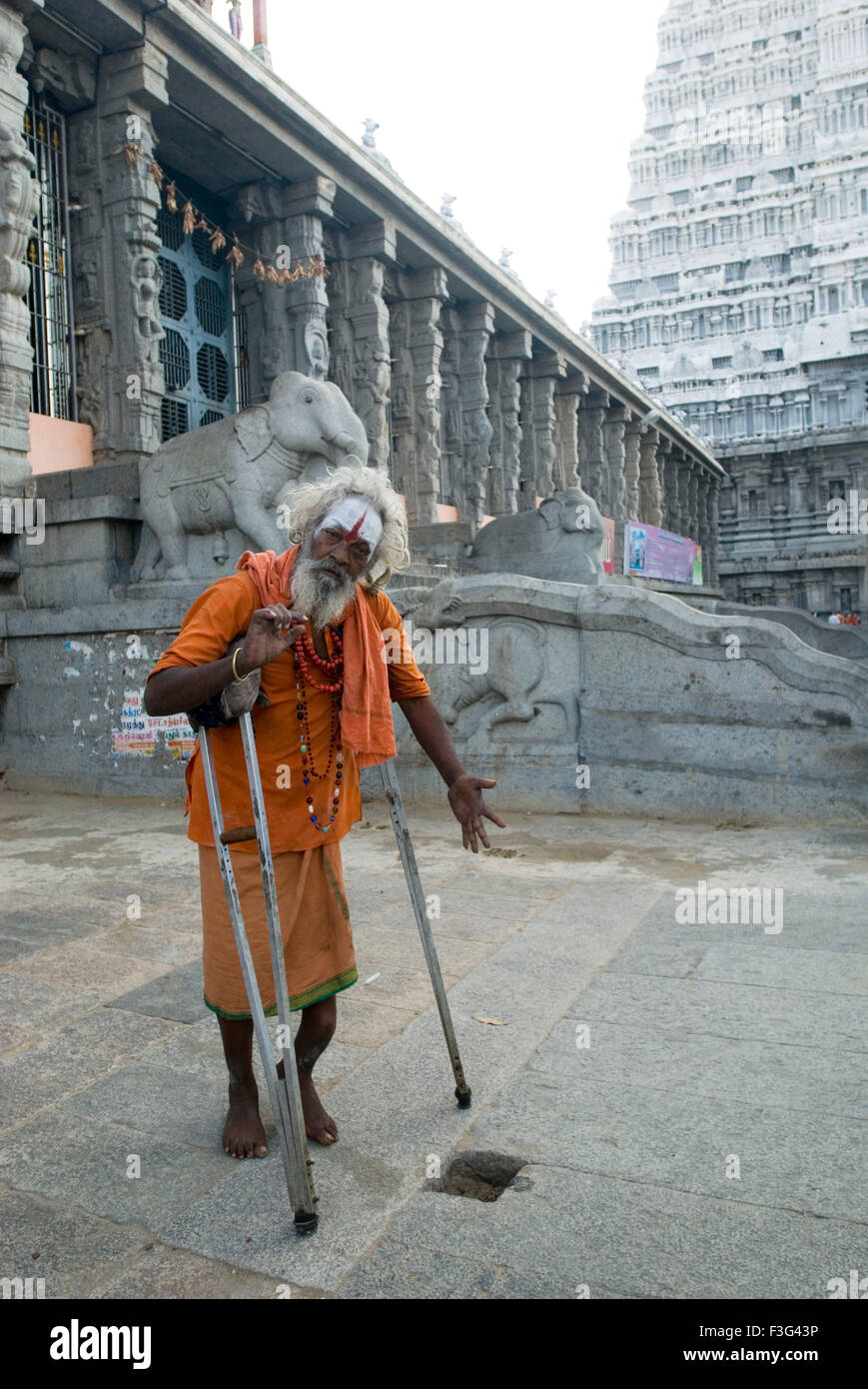 Handicapped sadhu at Thiruvannamalai temple ; Tamil Nadu ; India Stock Photo