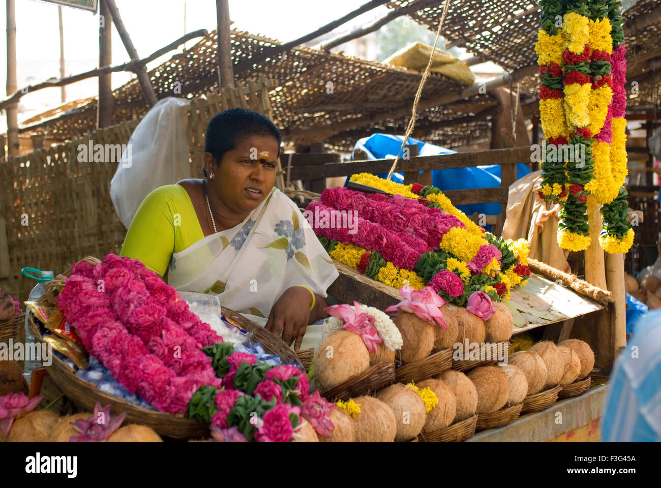 A woman selling Pooja integrant on stall at Thiruvannamalai temple ; Tamil Nadu ; India Stock Photo