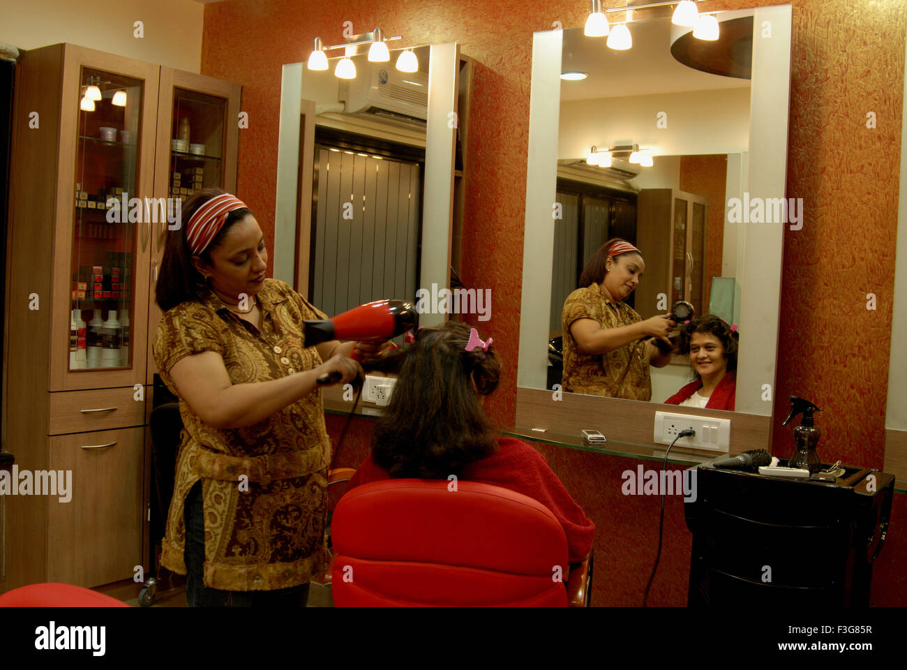 Hair styling and color highlighting treatment in beauty parlour at Vakola ;  Santacruz ; Mumbai Bombay ; Maharashtra Stock Photo - Alamy