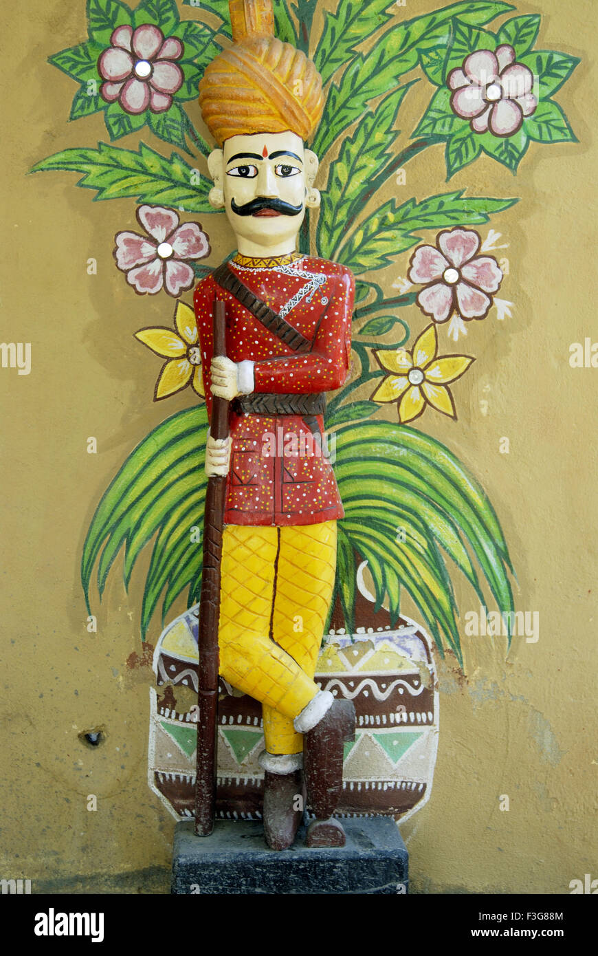 Statue of Rajasthani gate keeper holding gun on his hand at Nakharelidani village ; Indore ; Madhya Pradesh ; India Stock Photo