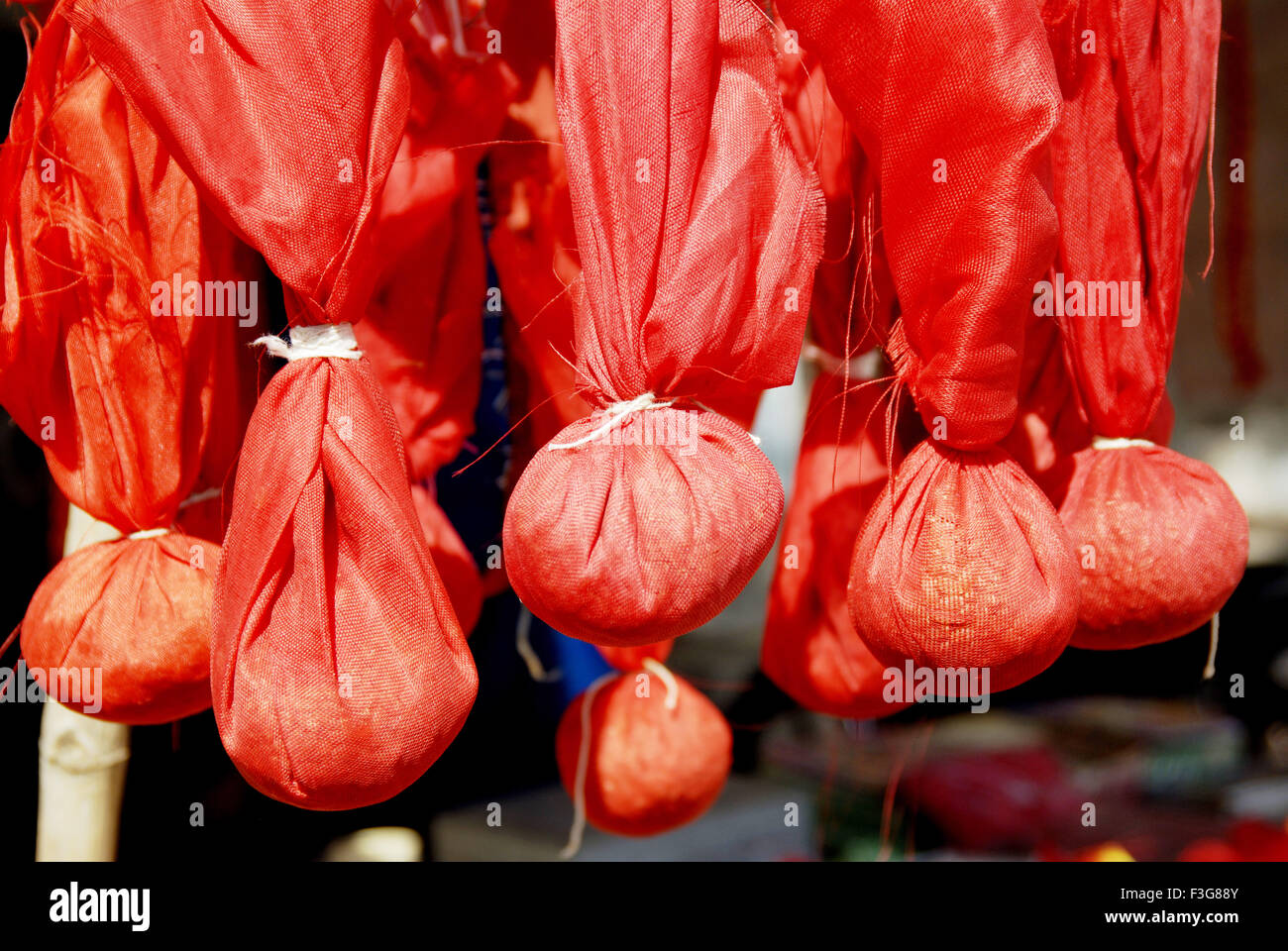 Orange sacks are hanged ; Ujjain ; Madhya Pradesh ; India Stock Photo