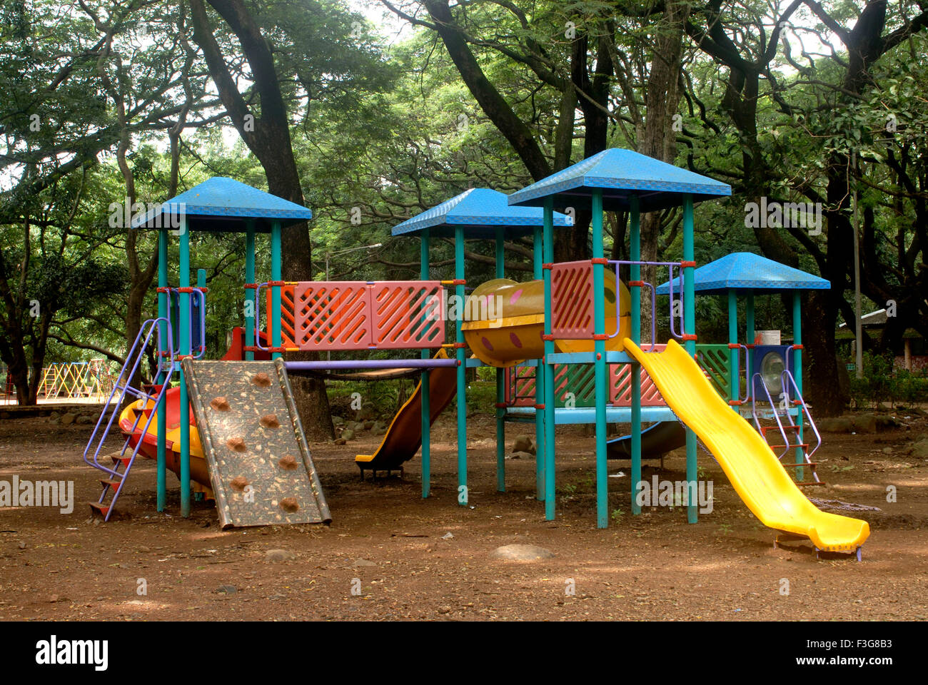 Various types of colourful slides play tool for children fitted at Sanjay Gandhi National Park ; Borivali Mumbai Stock Photo