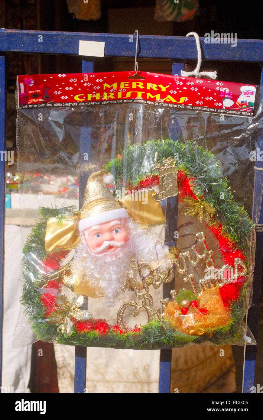 Wall hangingn transparent Plastic container face Santa Claus celebrating Christmas Festival kept sell shop Borivali Mumbai Stock Photo