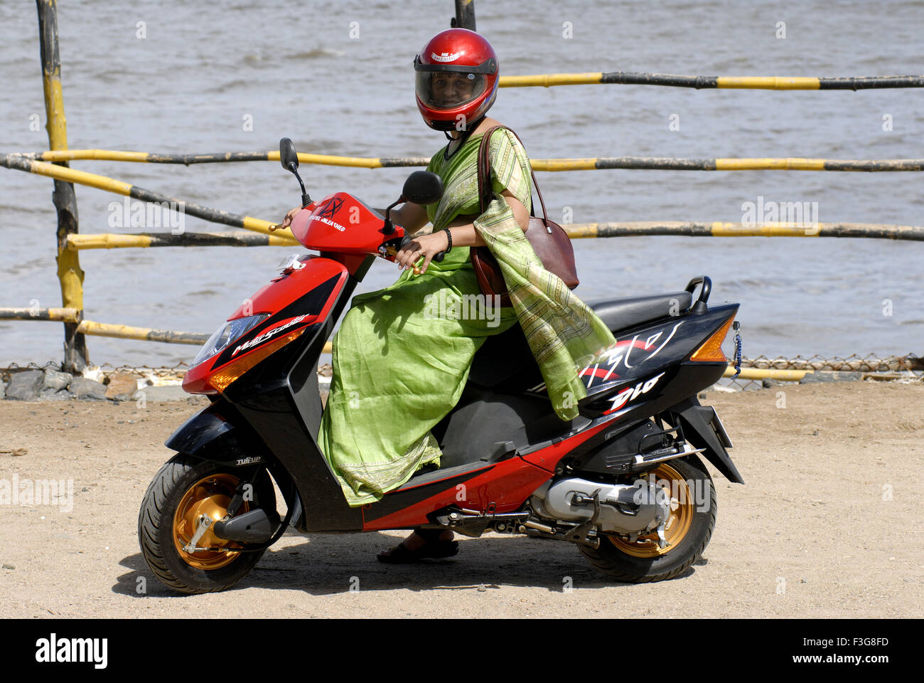 Working women driving Moto scooter ; Bombay now Mumbai ; Maharashtra ; India MR#721S Stock Photo